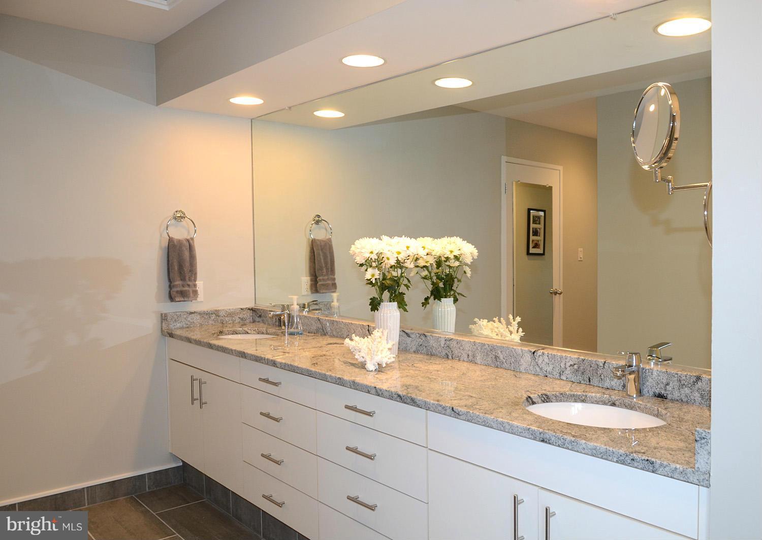 11030 Solaridge Drive Reston, VA 20191 - Photo 21 of 30 a bathroom with a granite countertop double vanity and a mirror