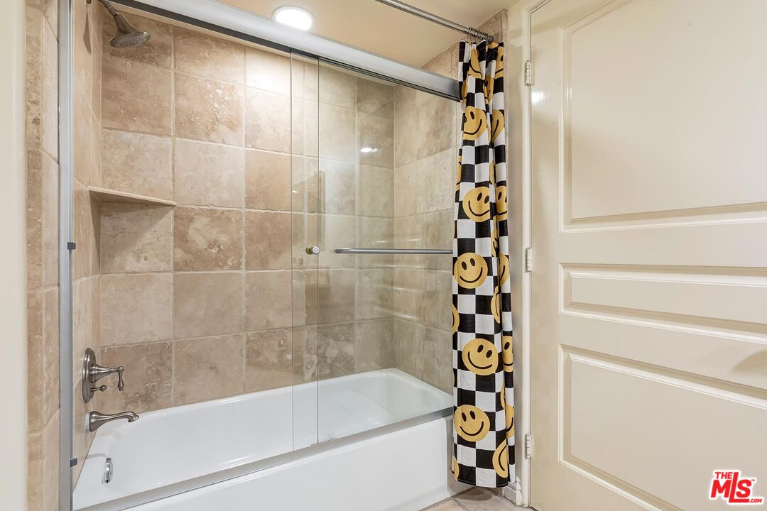 10795 Wilshire Boulevard, Unit 403 Los Angeles, CA 90024 - Photo 12 of 27 a bathroom with a bathtub and a shower