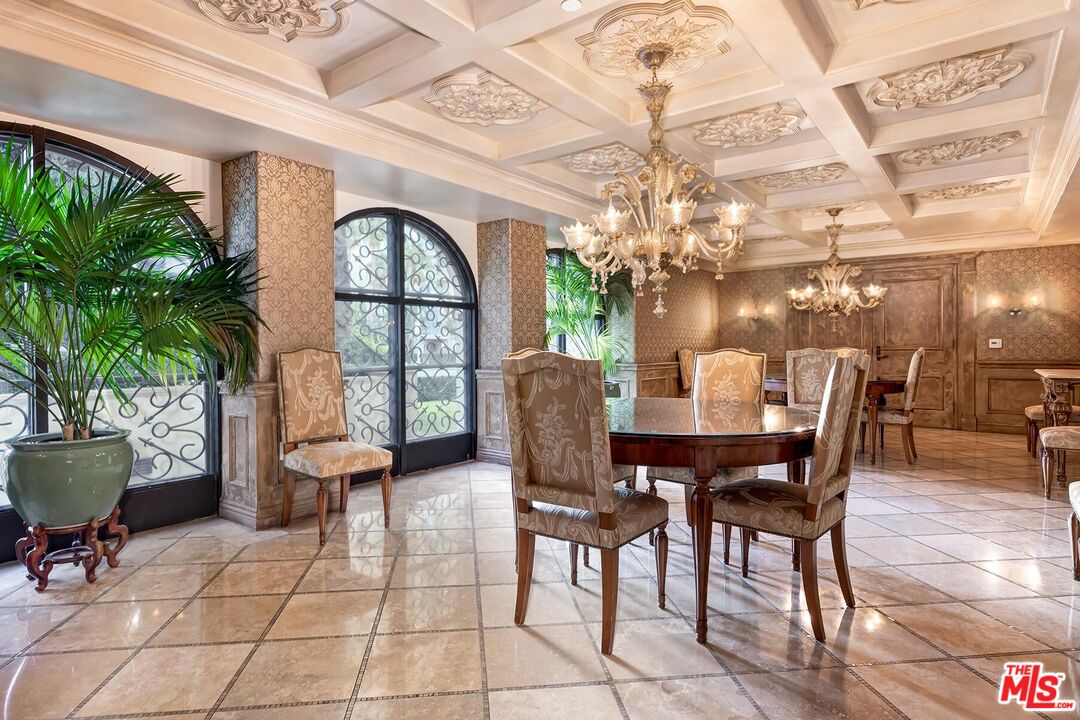 10795 Wilshire Boulevard, Unit 403 Los Angeles, CA 90024 - Photo 21 of 27 a dining room with furniture a chandelier and window