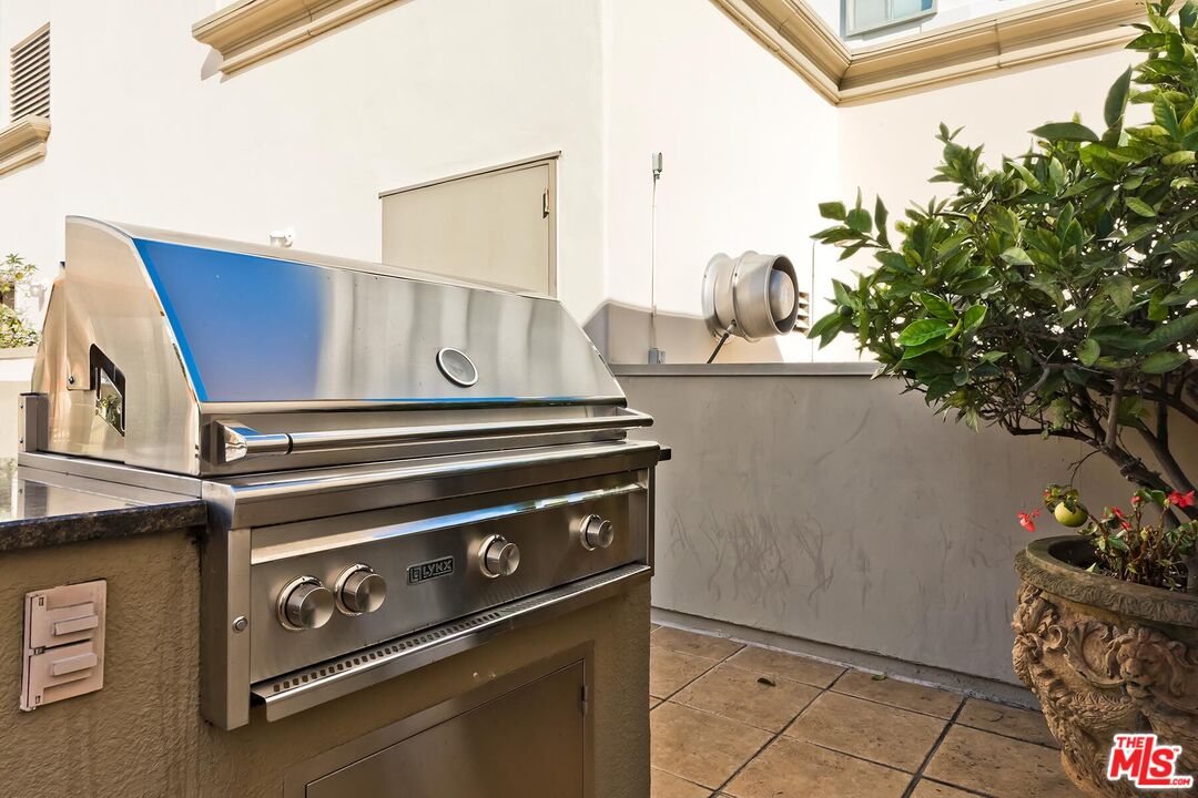 10795 Wilshire Boulevard, Unit 403 Los Angeles, CA 90024 - Photo 24 of 27 a stove top oven sitting inside of a kitchen