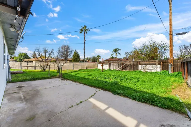 a yellow house with garden in front of it
