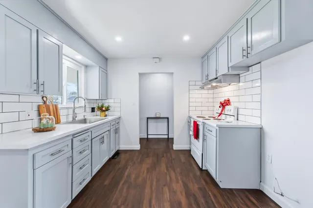 a kitchen with sink cabinets and window