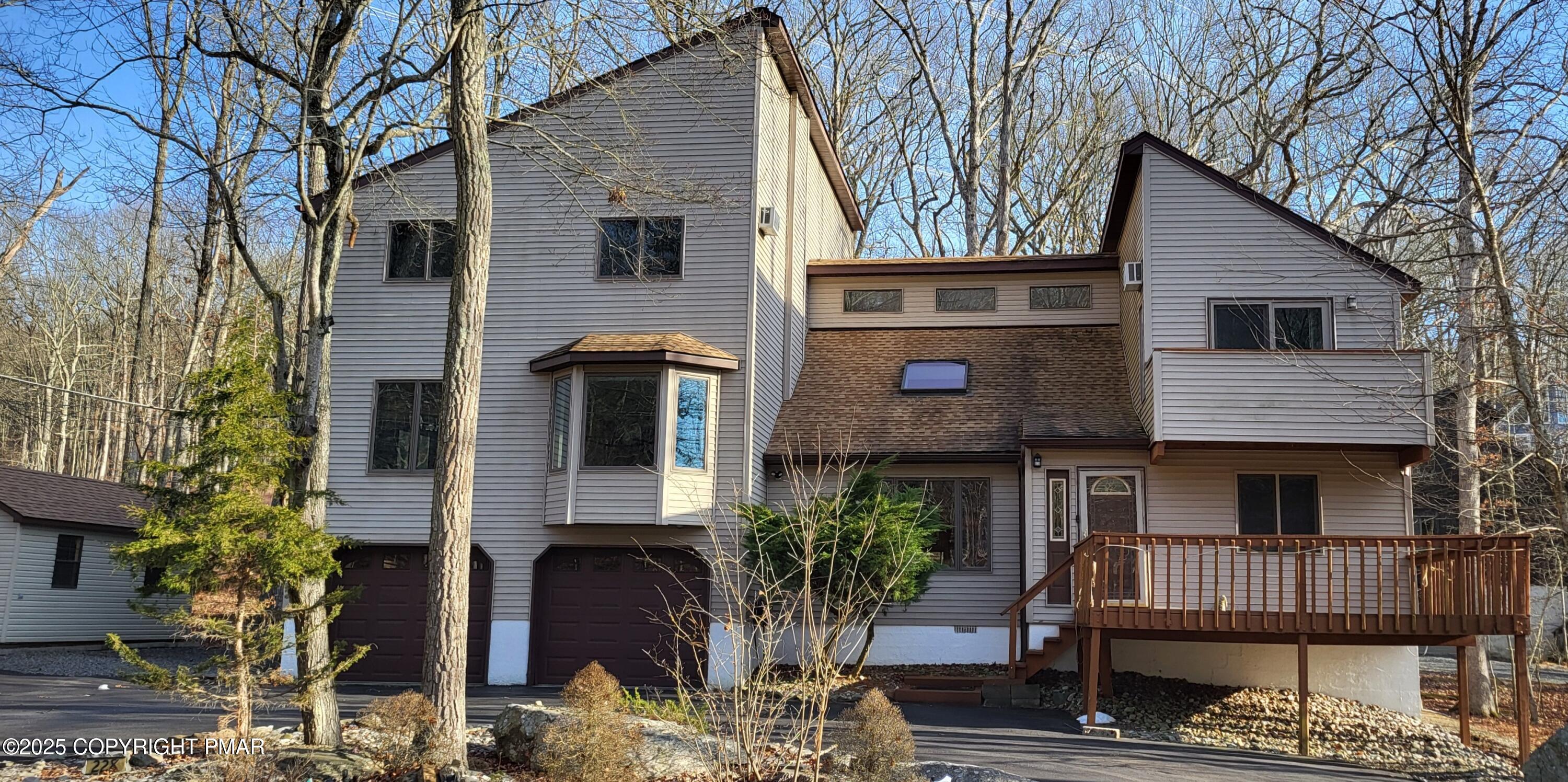 228 Edinburgh Road Bushkill, PA 18324 - Photo 2 of 77 a front view of a house with a garden