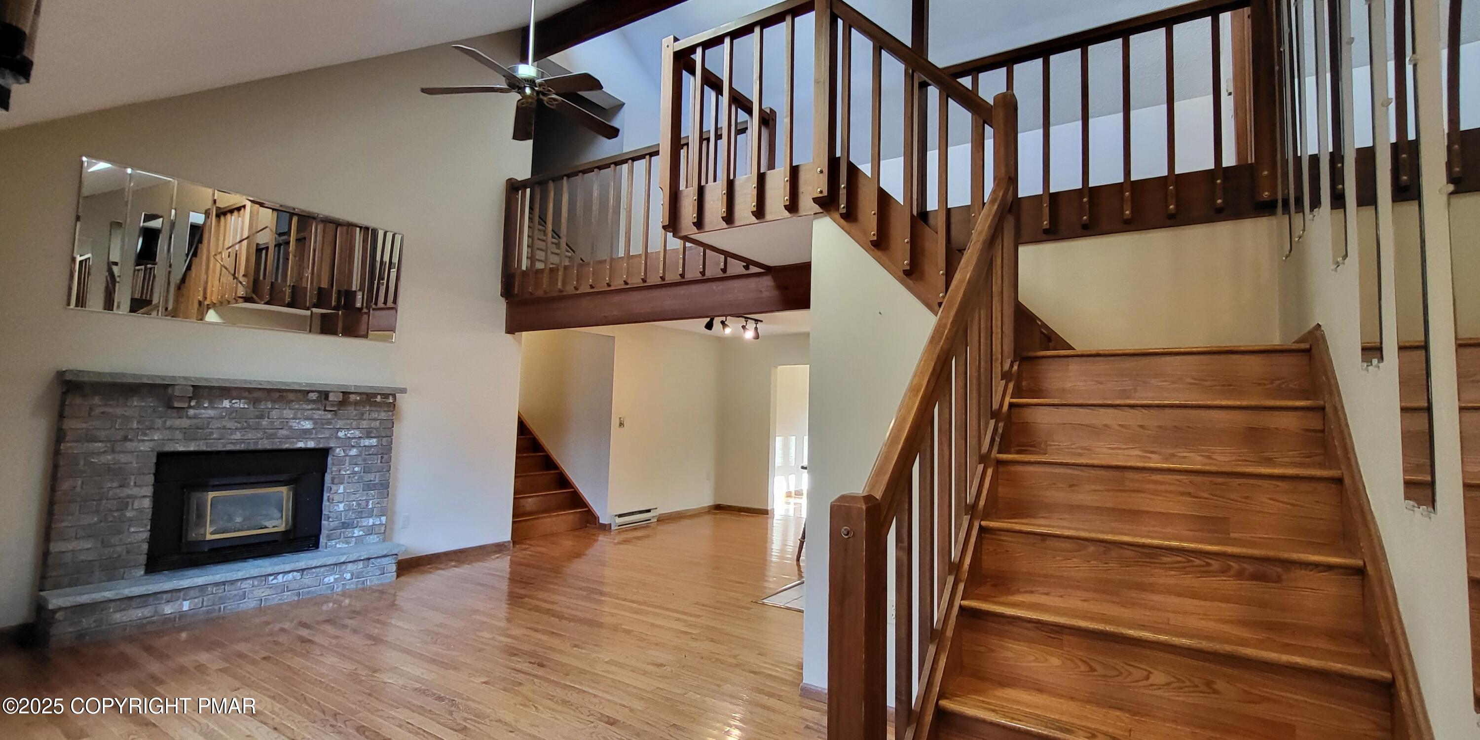 228 Edinburgh Road Bushkill, PA 18324 - Photo 4 of 77 a view of staircase with white walls and a fireplace