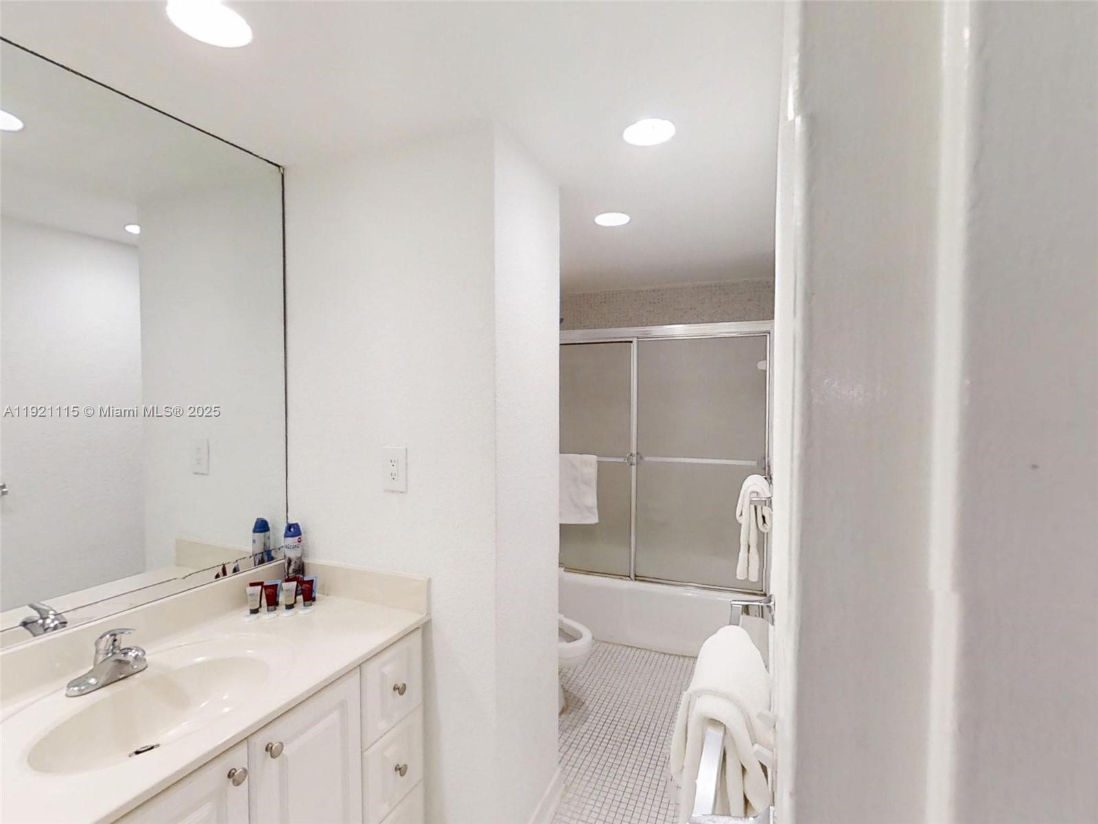 4001 South Ocean Drive, Unit PH7 Hollywood, FL 33019 - Photo 13 of 14 a bathroom with a sink toilet and shower
