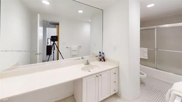a en suite bathroom with a sink and a mirror