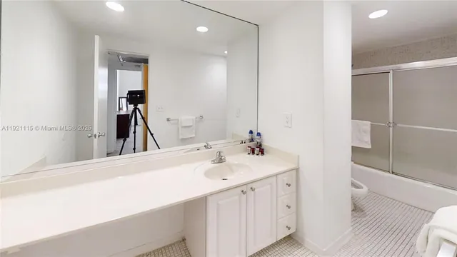 a en suite bathroom with a sink and a mirror