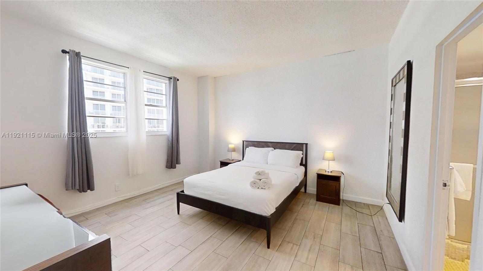 4001 South Ocean Drive, Unit PH7 Hollywood, FL 33019 - Photo 7 of 14 a bedroom with a bed and wooden floor