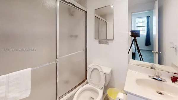 a bathroom with a sink toilet and shower