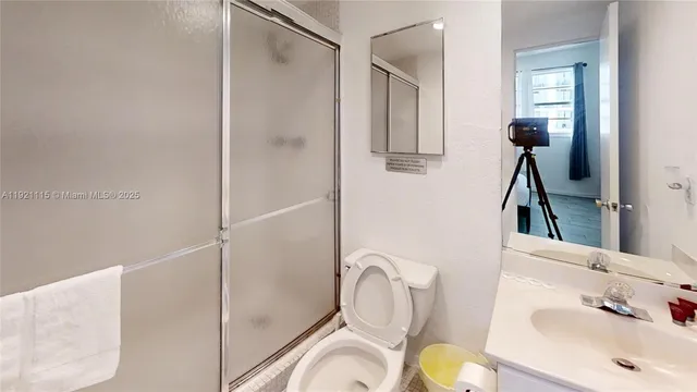 a bathroom with a sink toilet and shower
