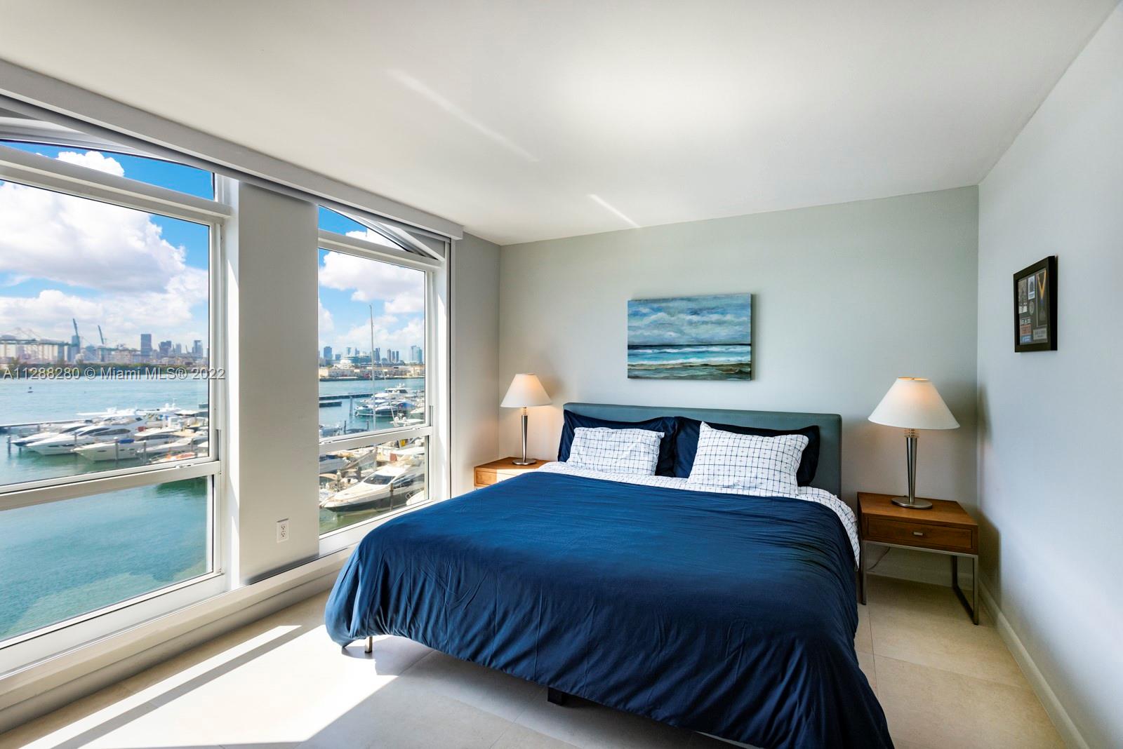 90 Alton Road, Unit 4 Miami Beach, FL 33139 - Photo 11 of 20 a bedroom with a large bed and a large window