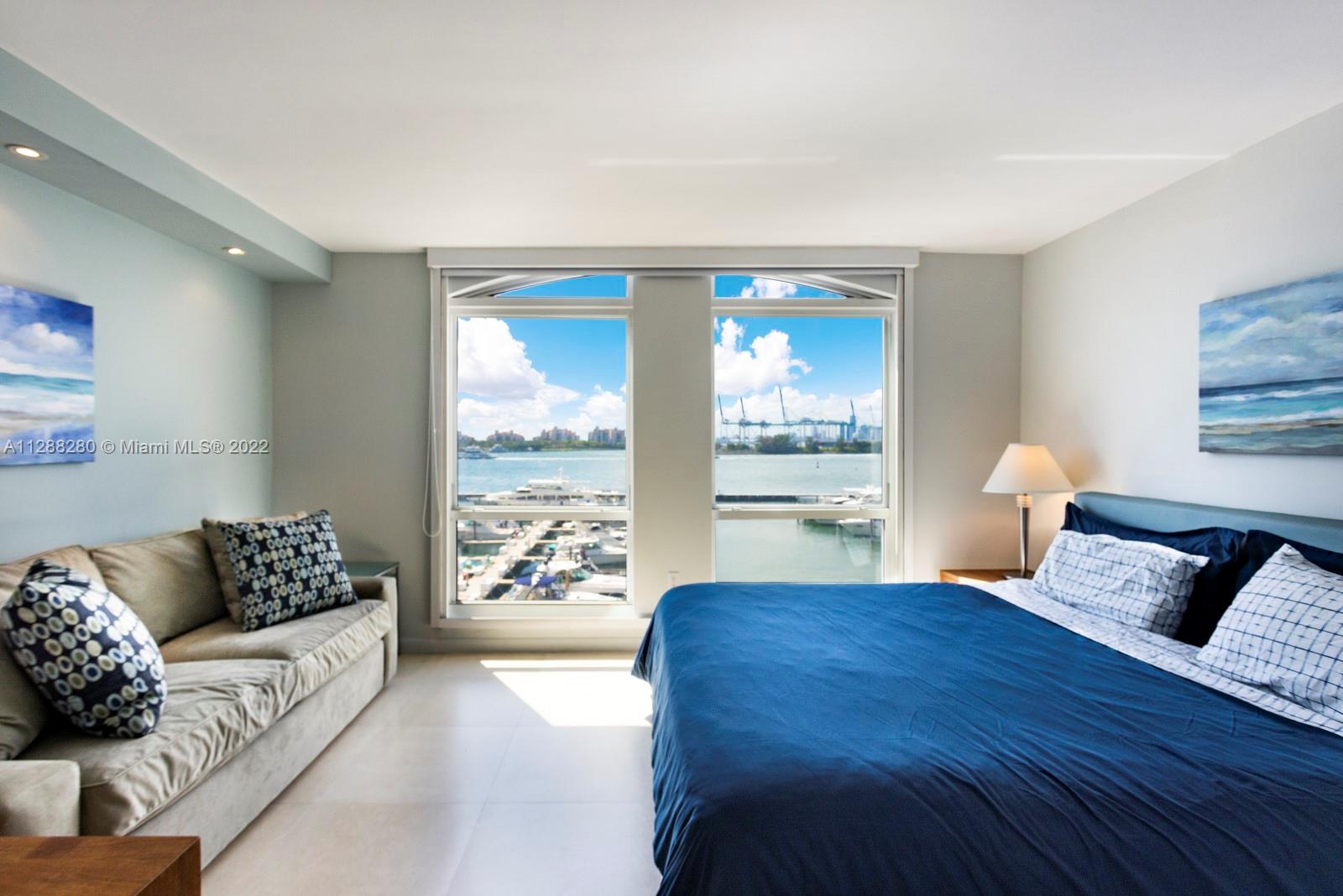 90 Alton Road, Unit 4 Miami Beach, FL 33139 - Photo 15 of 20 a living room with furniture and large windows