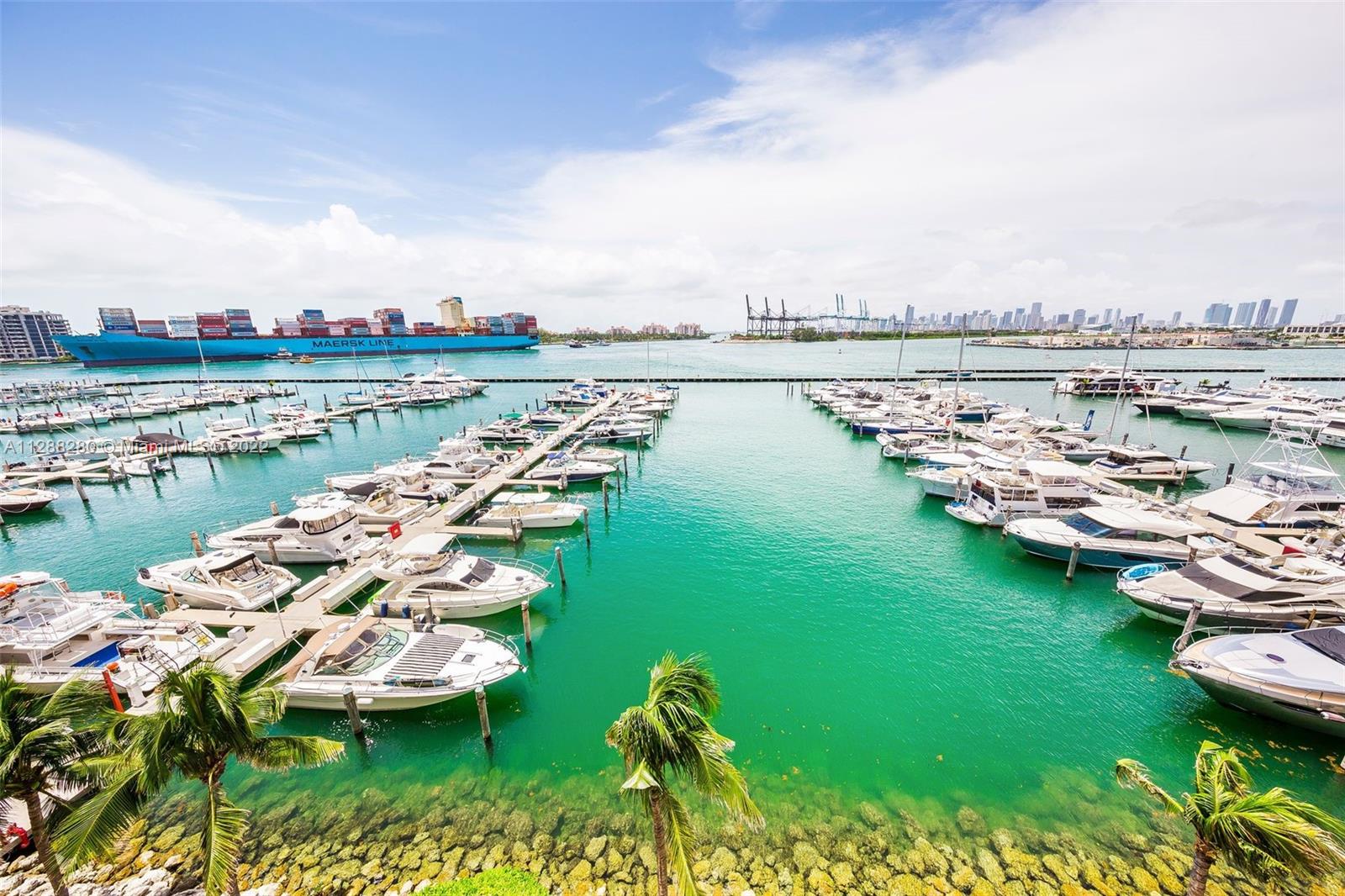 90 Alton Road, Unit 4 Miami Beach, FL 33139 - Photo 19 of 20 a view of a lake with a table and chairs