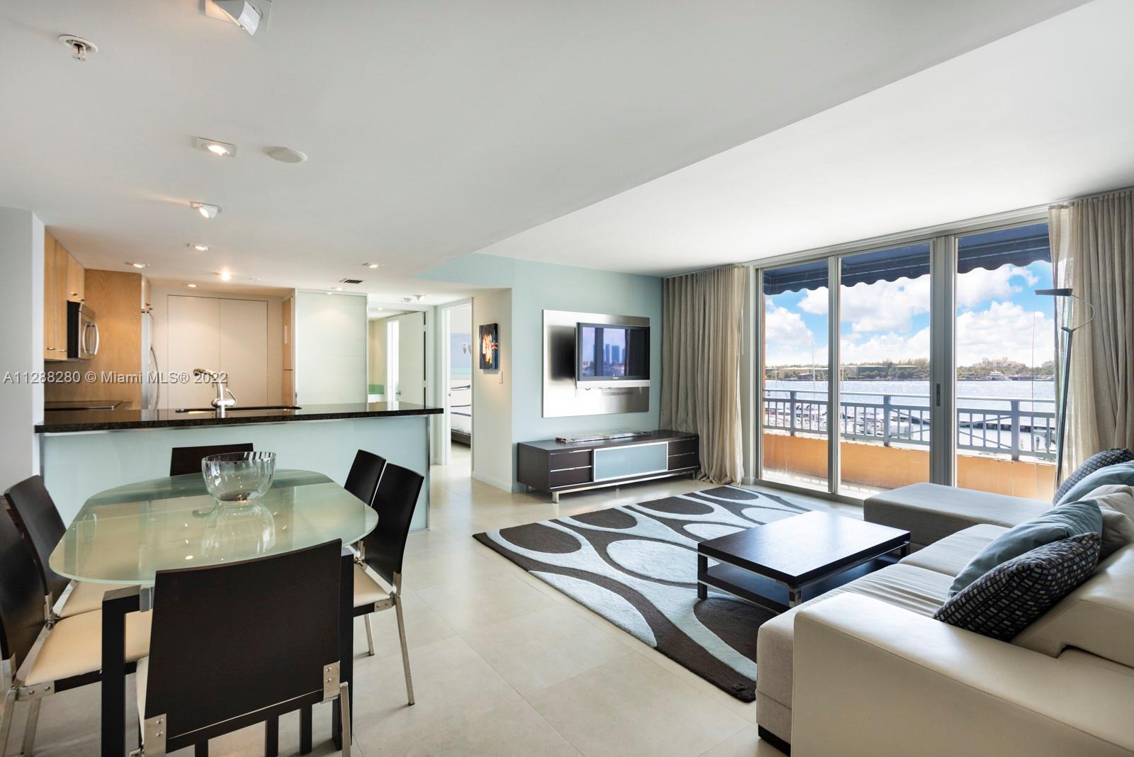 90 Alton Road, Unit 4 Miami Beach, FL 33139 - Photo 2 of 20 a living room with furniture and a table