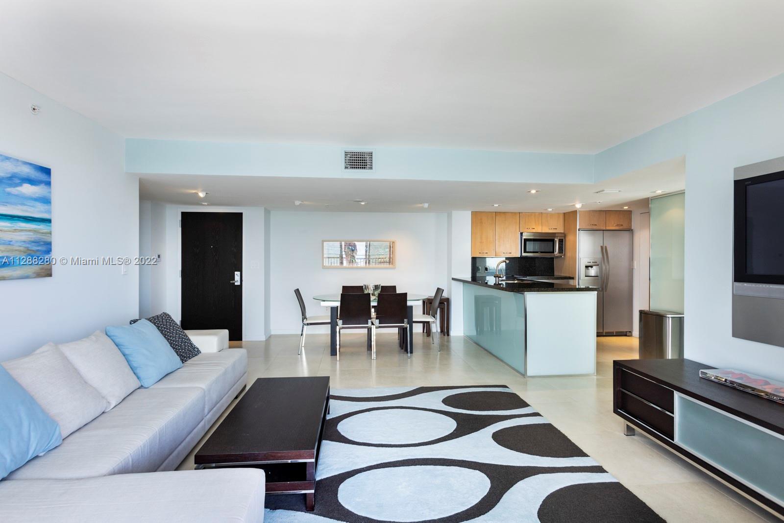 90 Alton Road, Unit 4 Miami Beach, FL 33139 - Photo 7 of 20 a kitchen with a dining table and chairs