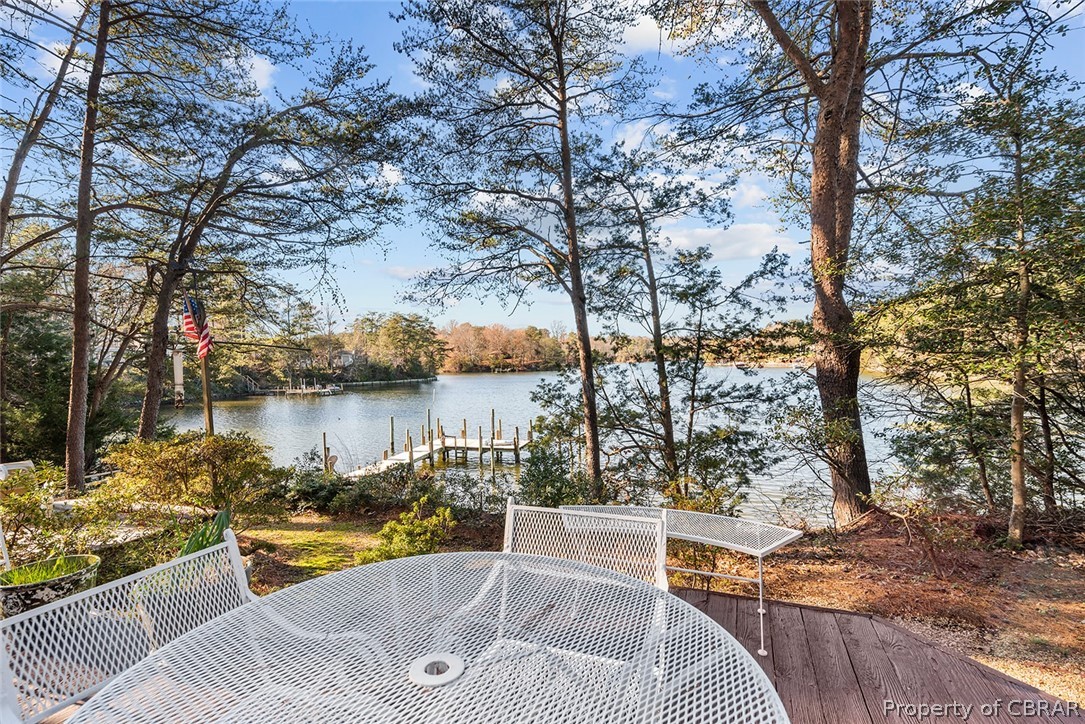 541 Cove Colony Road Lancaster, VA 22503 - Photo 29 of 38 a view of a lake with couches and wooden fence