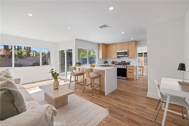 a living room with fireplace furniture and a wooden floor