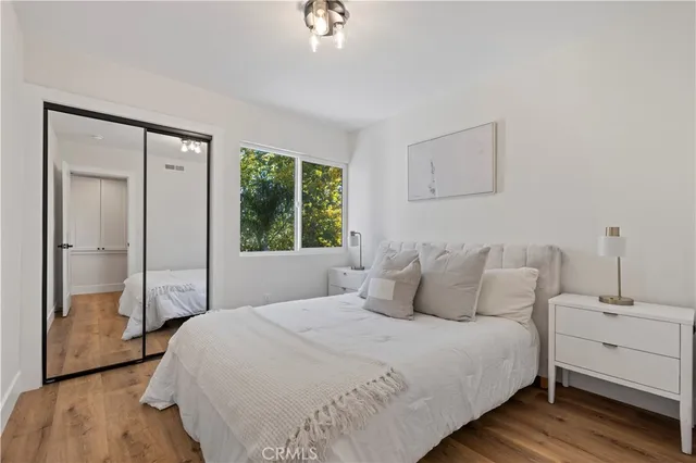 a bedroom with a bed and a mirror