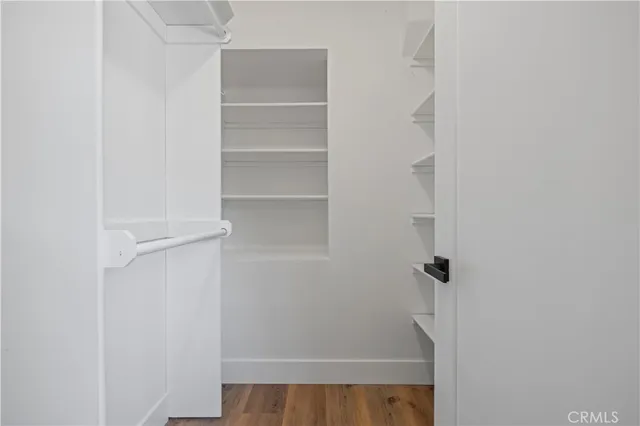 a view of walk in closet with empty racks