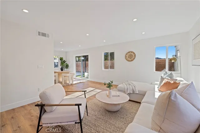 a dining room with furniture and wooden floor
