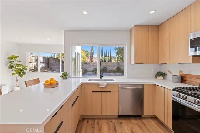 a kitchen with a sink a stove cabinets and counter space