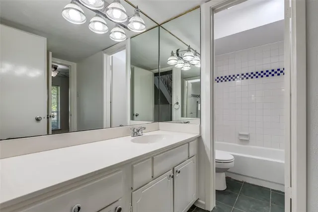 a bathroom with a sink a toilet and bathtub