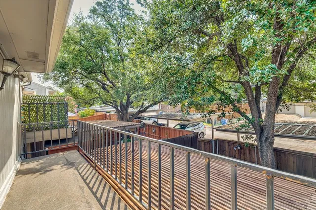 a view of balcony with wooden floor and fence