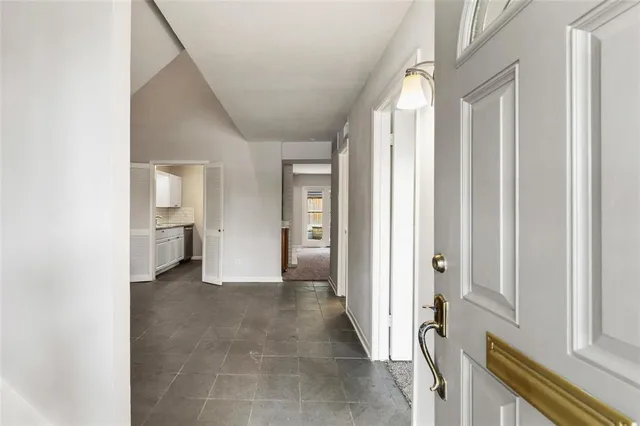 a view of a room with a furniture and front door