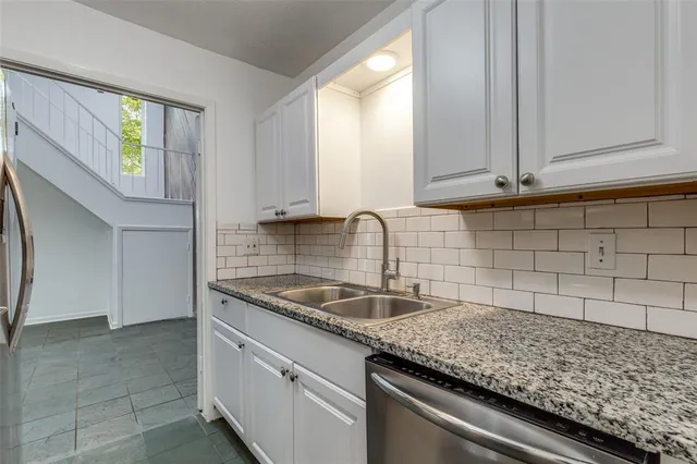 a kitchen with granite countertop a sink and a window