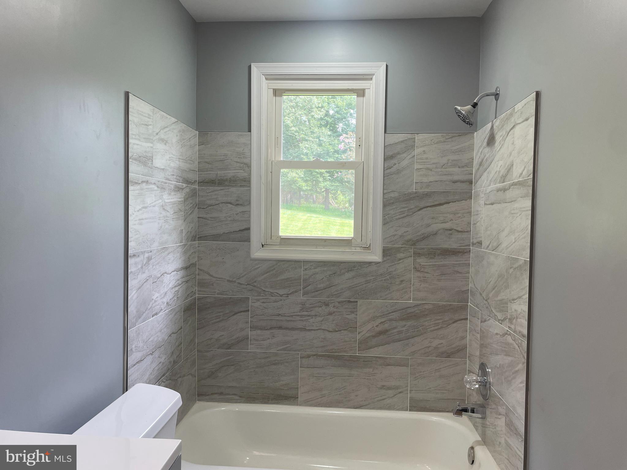13409 Doncaster Lane Silver Spring, MD 20904 - Photo 15 of 37 a bathroom with a window bathtub and toilet