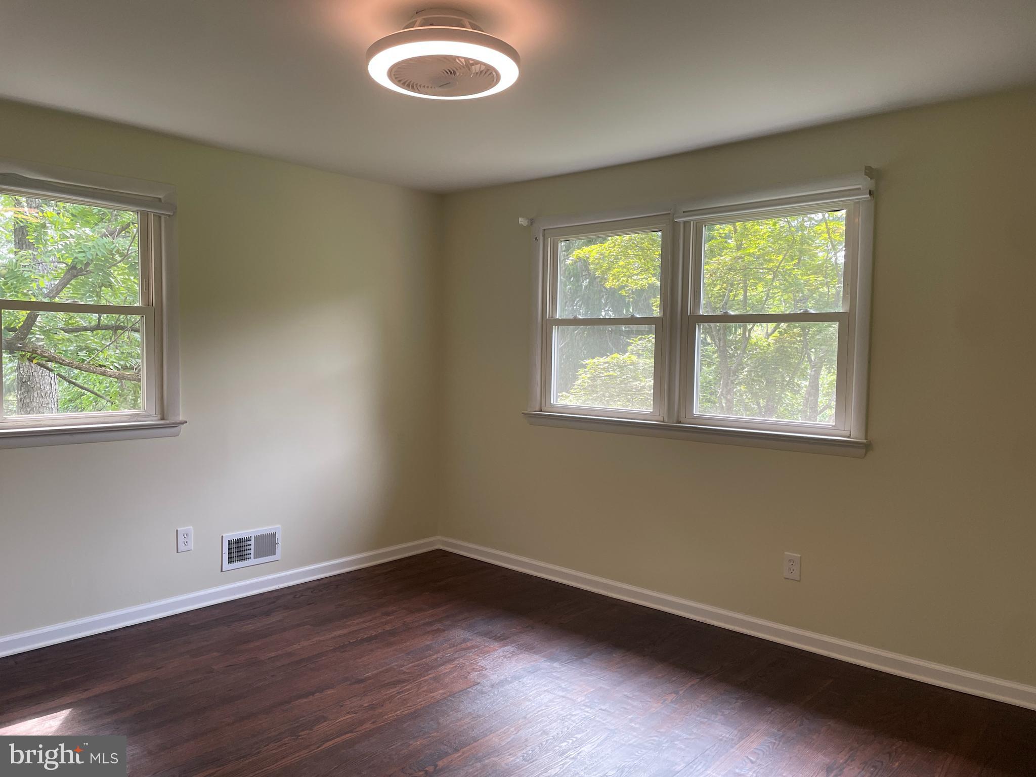 13409 Doncaster Lane Silver Spring, MD 20904 - Photo 21 of 37 an empty room with wooden floor and windows