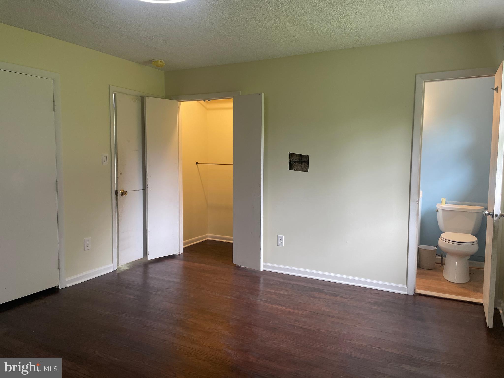 13409 Doncaster Lane Silver Spring, MD 20904 - Photo 23 of 37 a view of an empty room with wooden floor and a toilet