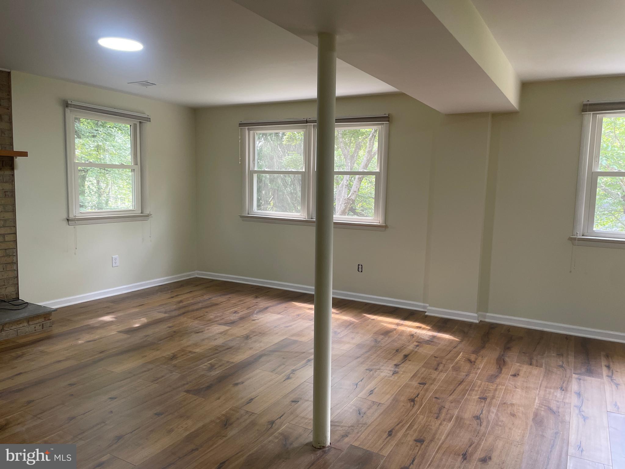 13409 Doncaster Lane Silver Spring, MD 20904 - Photo 28 of 37 an empty room with wooden floor and windows