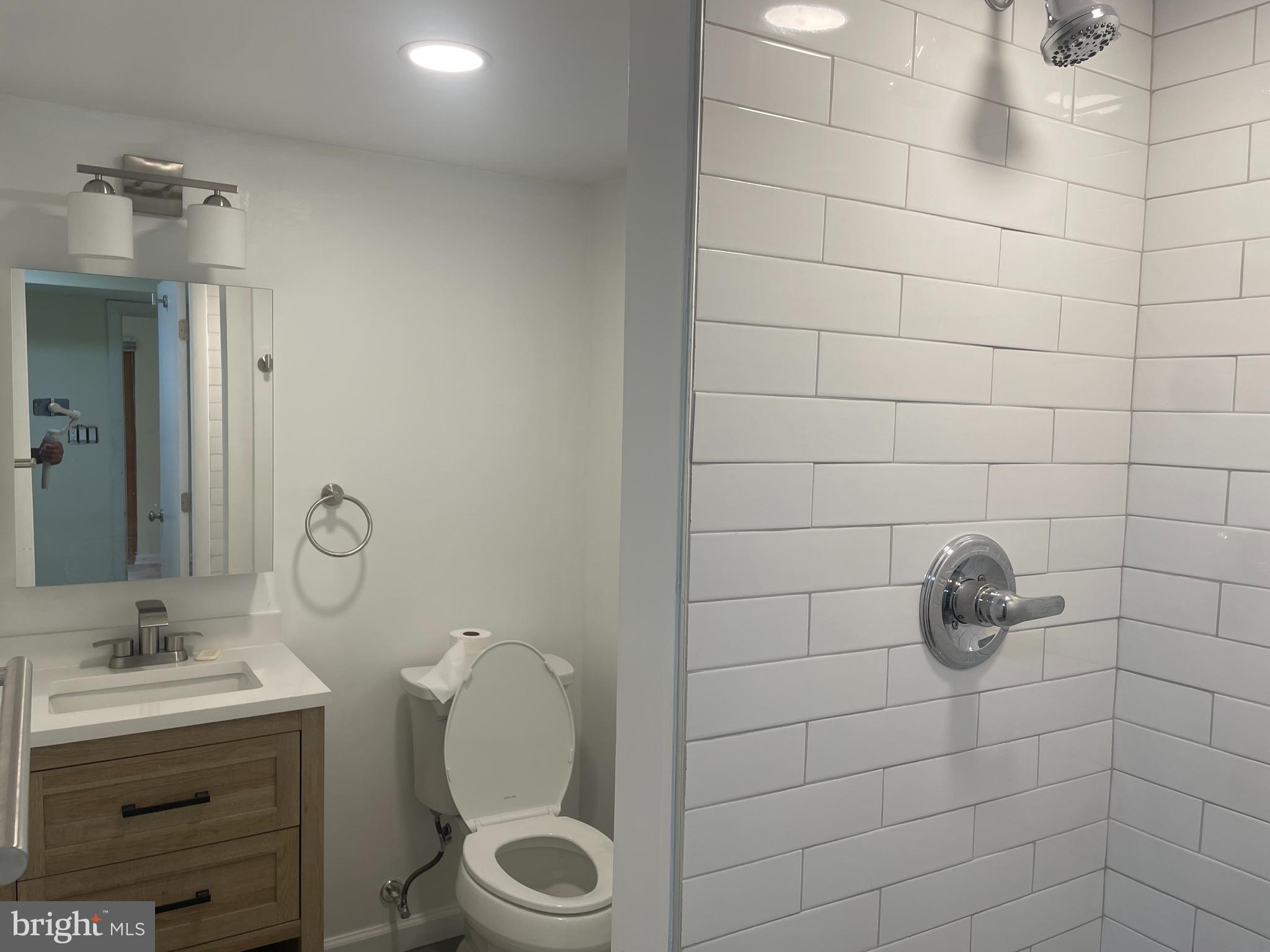 13409 Doncaster Lane Silver Spring, MD 20904 - Photo 30 of 37 a bathroom with a granite countertop sink a toilet and a mirror