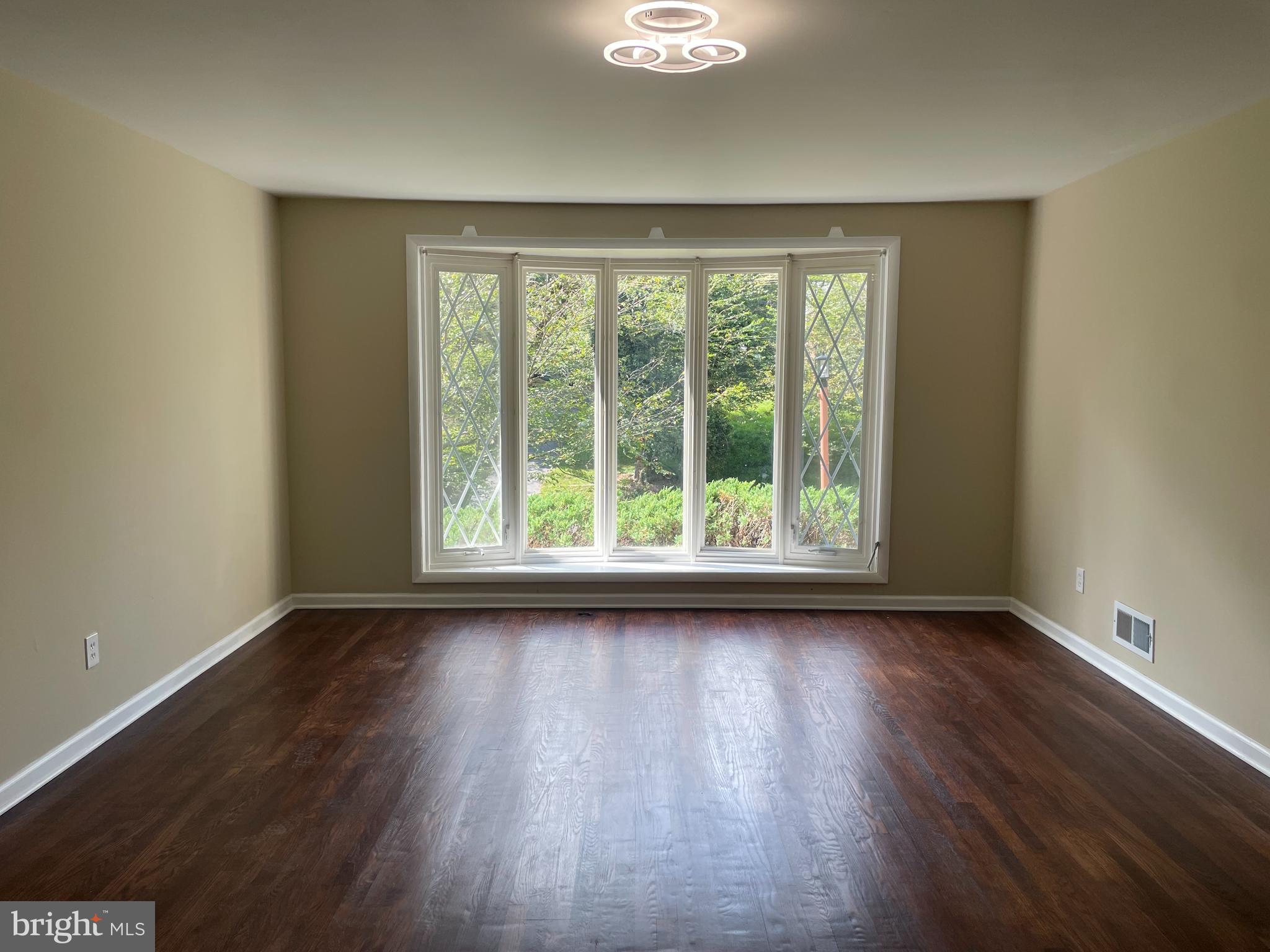 13409 Doncaster Lane Silver Spring, MD 20904 - Photo 5 of 37 a view of an empty room with wooden floor and a window