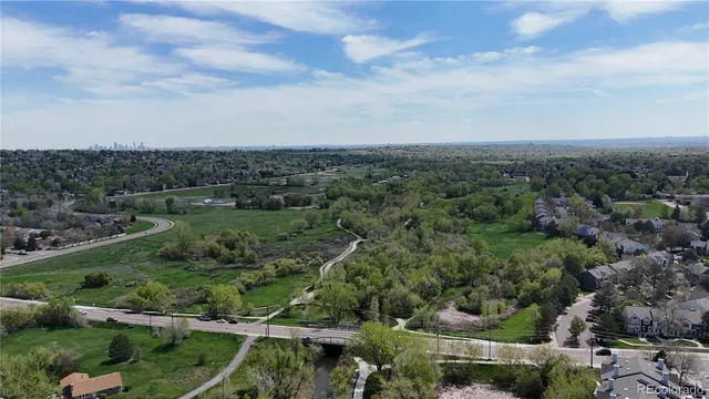 an aerial view of a residential houses with outdoor space and street view