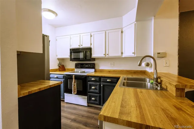 a kitchen with a sink appliances and cabinets