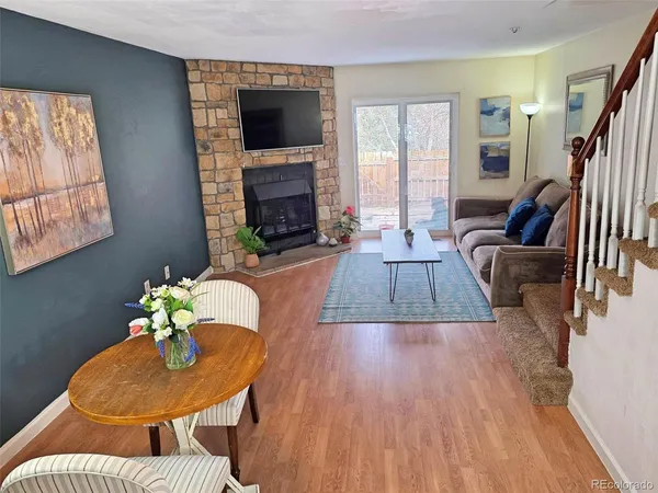 a living room with fireplace furniture and a flat screen tv