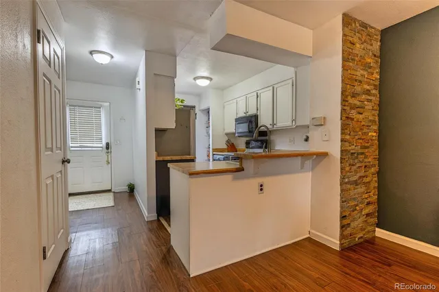 a kitchen with a refrigerator sink and cabinets