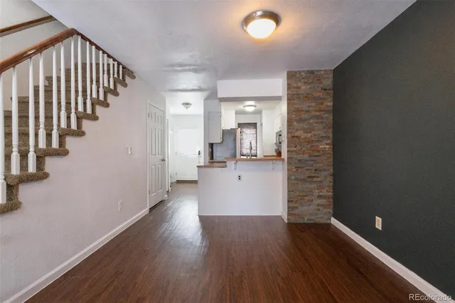 wooden floor in an empty room with a gallery