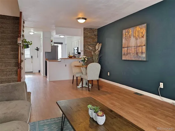 a living room with furniture and wooden floor