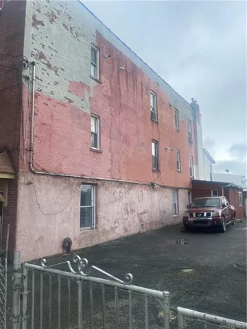a view of a car is parked in front of a building