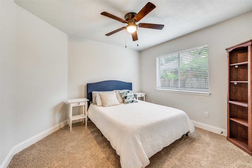 7306 Vista Ridge Lane Sachse, TX 75048 - Photo 17 of 23 a bedroom with a bed and a large window