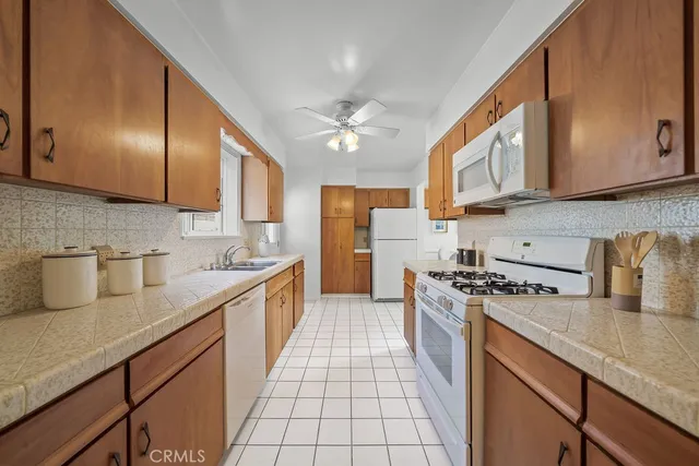 a kitchen with stainless steel appliances granite countertop a sink a stove and cabinets