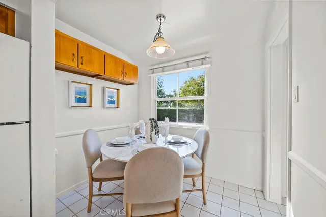 a dining room with furniture a chandelier and window
