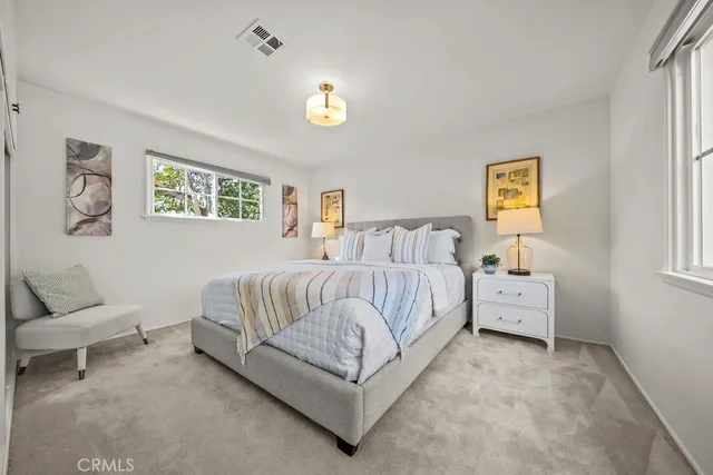 a spacious bedroom with a bed and a couch