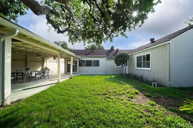 a view of a house with a yard porch and sitting area