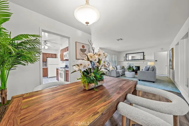 a living room with furniture potted plant and a chandelier