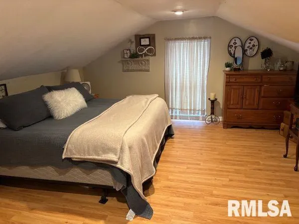 a bedroom with bed and window