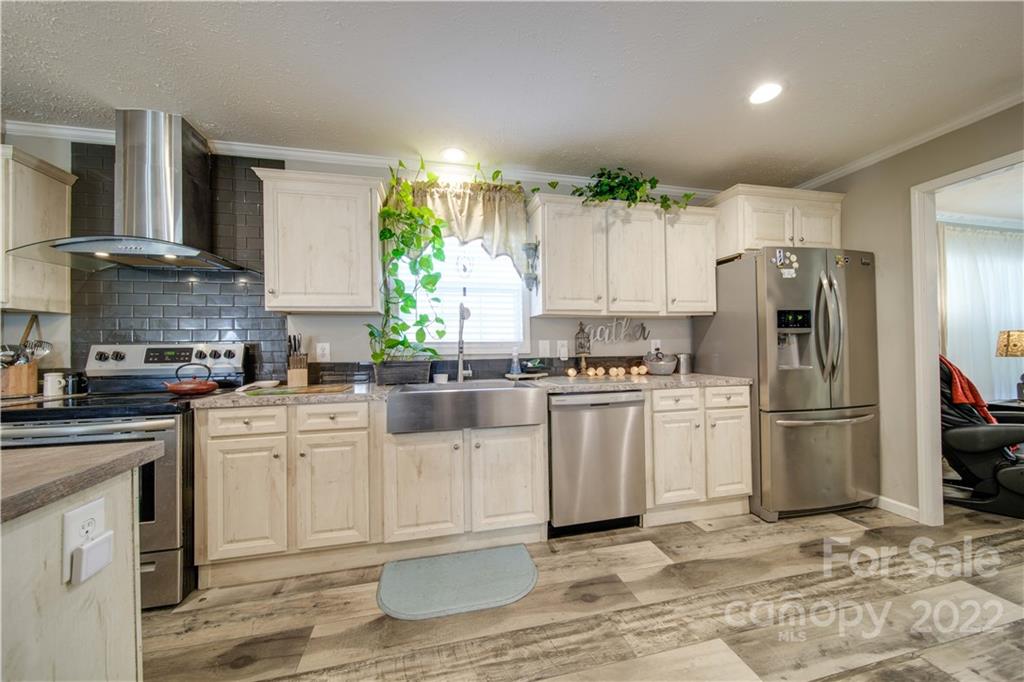 1540 Campbell Road Jefferson, SC 29718 - Photo 11 of 40 a kitchen with white cabinets and stainless steel appliances